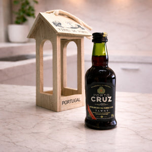Wooden lantern stand displayed beside the Porto Cruz Tawny Port wine bottle, highlighting the decorative Portugal engraving.