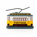 Portugal yellow tram souvenir figurine isolated on a white background, featuring a detailed miniature replica of the iconic Lisbon tram in traditional yellow colors.