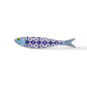 A ceramic sardine figurine with a blue and white intricate pattern, reminiscent of traditional Portuguese tiles. The fish's head is blue with a yellow eye, and the pattern runs along its body, segmented into four parts. The word "Portugal" is visible near the tail, making it a perfect souvenir.