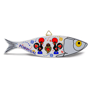 A fish-shaped souvenir wall decoration with "Portugal" written on its side, featuring three stylized roosters adorned in red, yellow, and blue detailing. The fish has a yellow eye and a triangular hanger at the top, making it an eye-catching piece for any space.