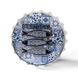 A bottle cap featuring a design of three fish with intricate patterns on a blue and white tiled background. The word "Portugal" is prominently displayed above the fish. The edges of the cap have a classic crimped design, and it doubles as a magnet for added functionality.