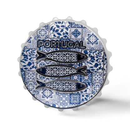 A bottle cap featuring a design of three fish with intricate patterns on a blue and white tiled background. The word "Portugal" is prominently displayed above the fish. The edges of the cap have a classic crimped design, and it doubles as a magnet for added functionality.
