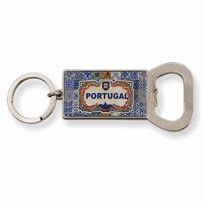 A souvenir keychain with a blue and colorful enamel rectangular pendant featuring intricate designs and the word "PORTUGAL." Attached to the pendant is a handy bottle opener at the bottom. The keychain ring is black.