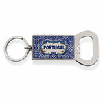 A rectangular keychain with an attached bottle opener featuring intricate blue designs and the word "Portugal" in the center. The circular, metallic ring contrasts beautifully with the blue and silver-toned opener, making it a perfect keepsake or magnet for any travel enthusiast.
