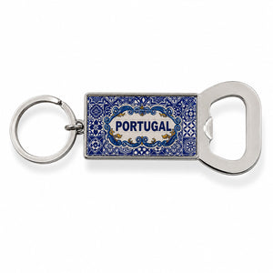 A rectangular keychain with an attached bottle opener featuring intricate blue designs and the word "Portugal" in the center. The circular, metallic ring contrasts beautifully with the blue and silver-toned opener, making it a perfect keepsake or magnet for any travel enthusiast.