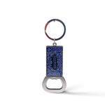 A rectangular keychain with an attached bottle opener featuring intricate blue designs and the word "Portugal" in the center. The circular, metallic ring contrasts beautifully with the blue and silver-toned opener, making it a perfect keepsake or magnet for any travel enthusiast.