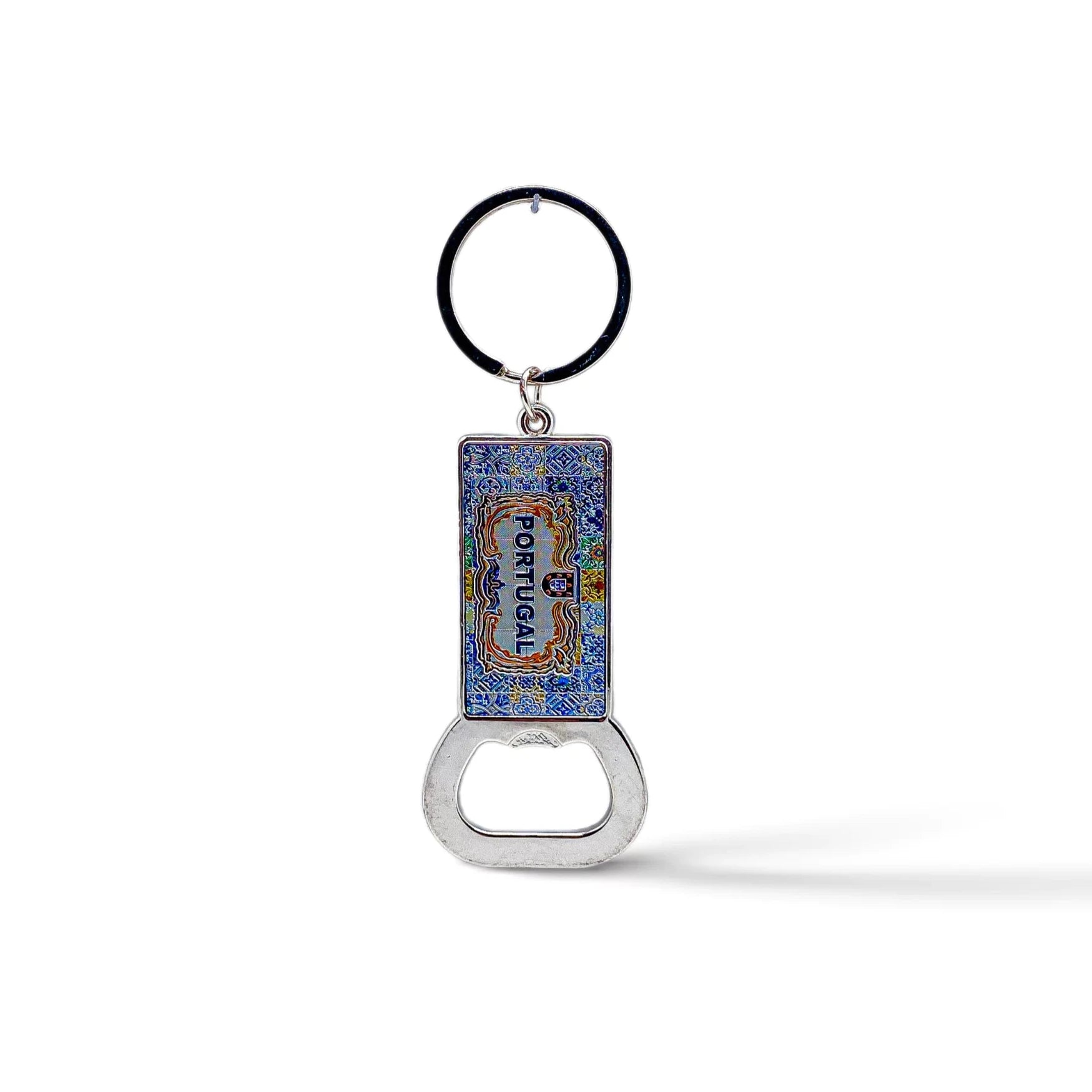 A souvenir keychain with a blue and colorful enamel rectangular pendant featuring intricate designs and the word "PORTUGAL." Attached to the pendant is a handy bottle opener at the bottom. The keychain ring is black.