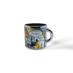 A colorful ceramic mug featuring intricate, vibrant artwork depicting scenes from Portugal. The designs include traditional motifs, landmarks, and a crest, with the word "Portugal" prominently displayed in the center. Perfect as a souvenir, the handle and rim have a metallic silver finish.