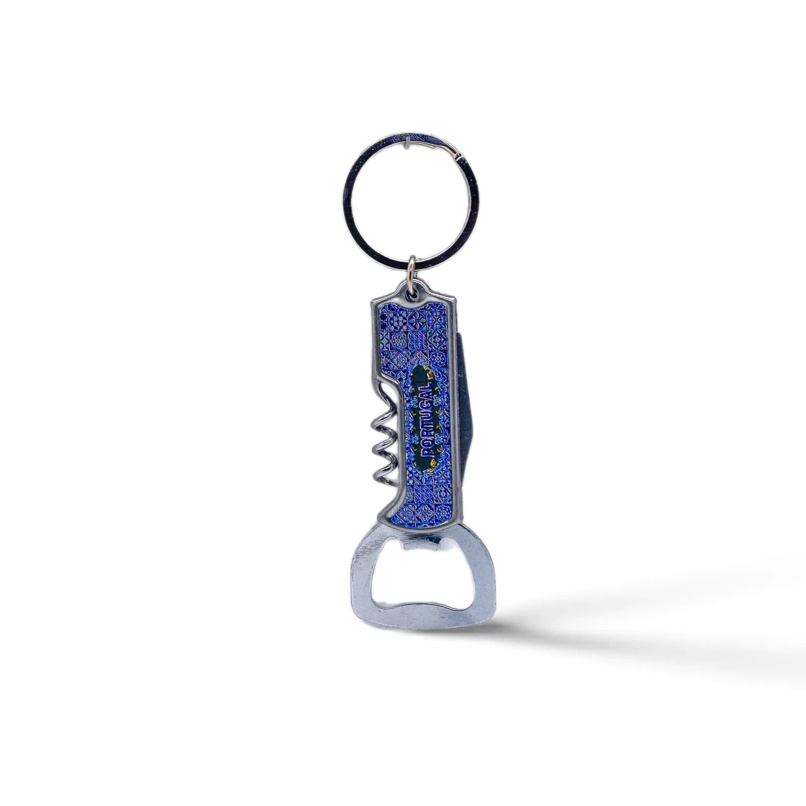 A silver metal keychain with an attached blue bottle opener featuring a decorative design. The multifunctional opener includes a corkscrew, a flat bottle cap opener, and a compact knife. This elegant souvenir stands out against its plain white background.
