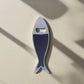 This metal bottle opener, designed as a sardine, is embellished with intricate, colorful details, including a famous Lisbon landmark and "Lisboa" text. The opener hole is positioned at the fish's eye, adding a unique touch to this Portugal keepsake.
