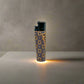 A lighter showcasing intricate patterns with "PORTUGAL" written vertically along the side. The top is black, while the base features an orange and black design inspired by traditional cork patterns. Set against a plain white background, this lighter stands out as a stylish souvenir.