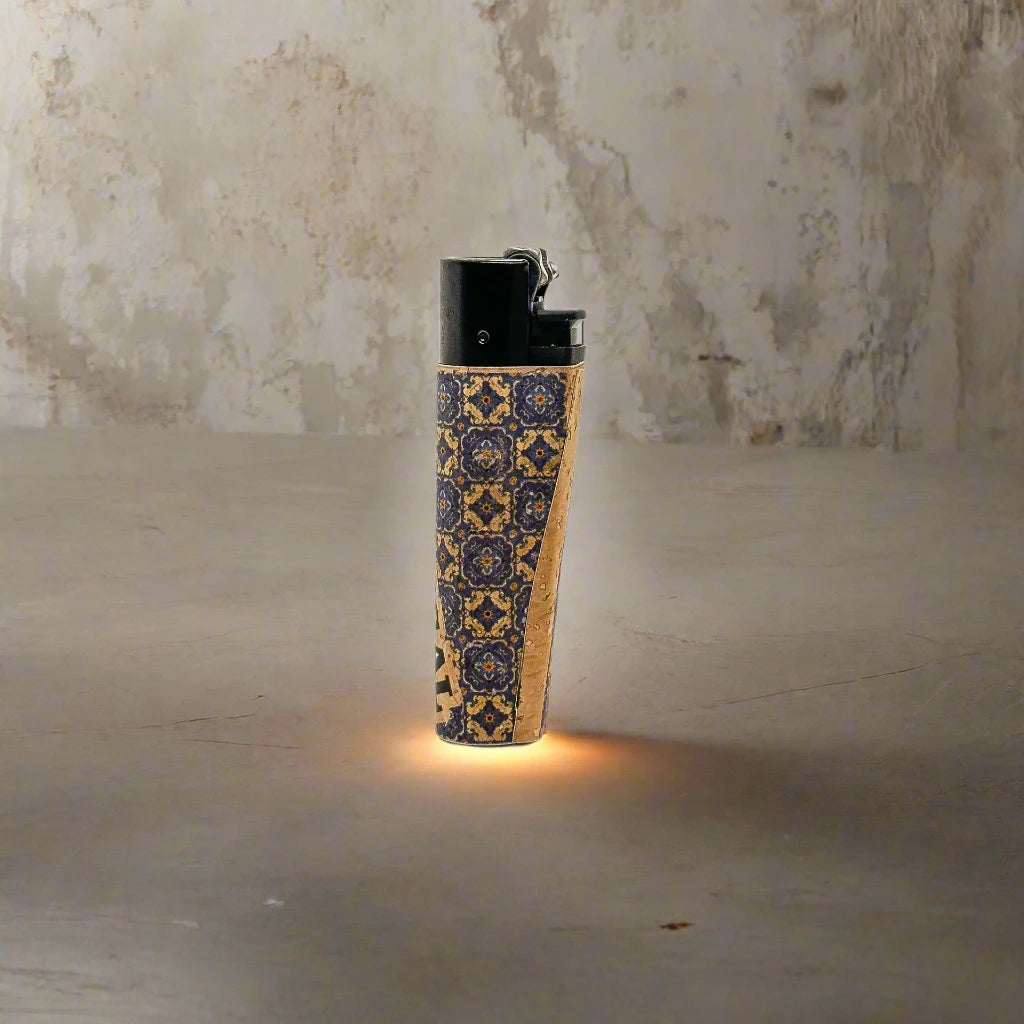This lighter features detailed patterns, with "PORTUGAL" written vertically along the side. The black top contrasts with the decorative base, which has an orange and black pattern reminiscent of classic cork designs. The white background highlights the lighter's unique style.