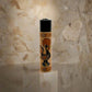 A souvenir lighter wrapped in a decorative design featuring the word "PORTUGAL" alongside traditional Portuguese artwork, including a vibrant rooster. The lighter's black top contrasts with the colorful wrap.