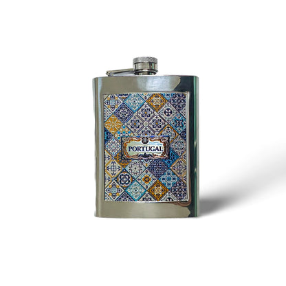 A stainless steel flask with a patchwork of blue, yellow, and white tile patterns and the word "PORTUGAL" in the center. The cap is attached with a small hinge, making it a perfect souvenir. The flask rests on a white background with a slight shadow on one side.