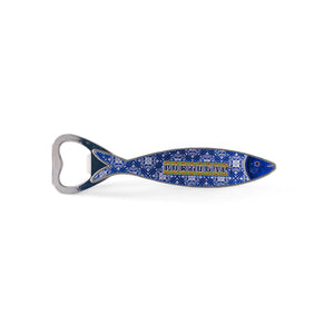 A metal fish-shaped bottle opener adorned with intricate blue and white patterns, reminiscent of Portuguese azulejos tiles. The word "Portugal" is prominently displayed on its side, and a small magnet on the back ensures it sticks to your fridge. The bottle opener end is at the fish's tail.