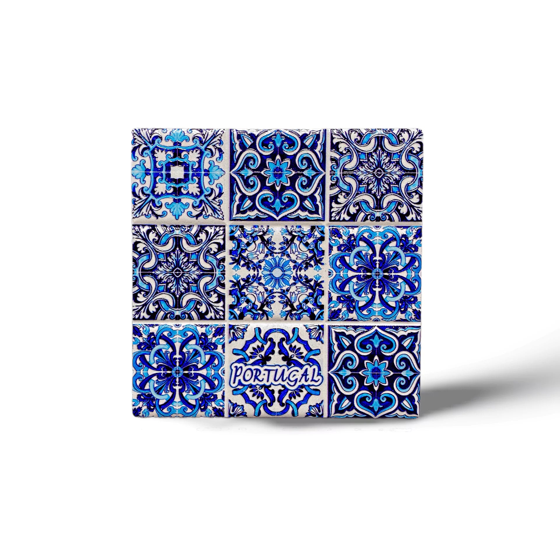 This detailed ceramic tile features a mix of vivid geometric and floral designs, with dominant hues of blue, and white. The word "PORTUGAL" is highlighted in white, making it a perfect memento for travelers or a striking addition to a cork coaster set.