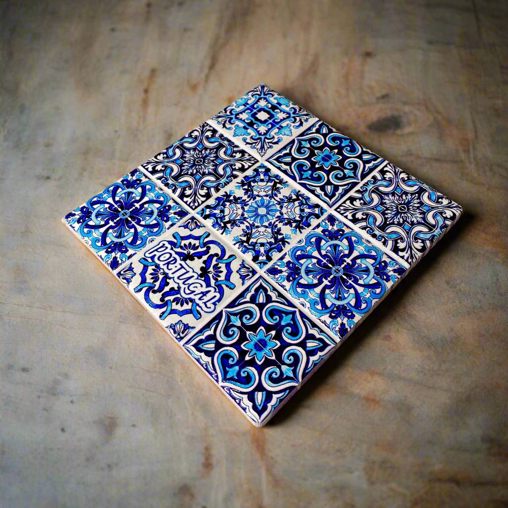 This intricate ceramic tile showcases a blend of vibrant geometric and floral patterns, primarily in shades of blue and white. The word "PORTUGAL" stands out in white, making it an ideal keepsake for travelers or a standout piece for any cork coaster collection.