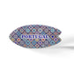 This oval-shaped ceramic object features a colorful mosaic pattern inspired by traditional Portuguese azulejo tiles. The word "PORTUGAL" is prominently written in blue uppercase letters in the center. It sits on a cork base, casting a soft shadow on the white surface.