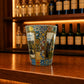 Viana do Castelo souvenir shot glass featuring Santa Luzia Sanctuary illustrations and colorful Portuguese azulejo tile artwork displayed on a wooden counter