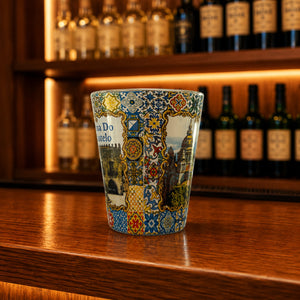 Viana do Castelo souvenir shot glass featuring Santa Luzia Sanctuary illustrations and colorful Portuguese azulejo tile artwork displayed on a wooden counter
