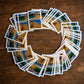 Albufeira souvenir playing cards arranged in a circular display showing Portugal-themed beach illustrations.