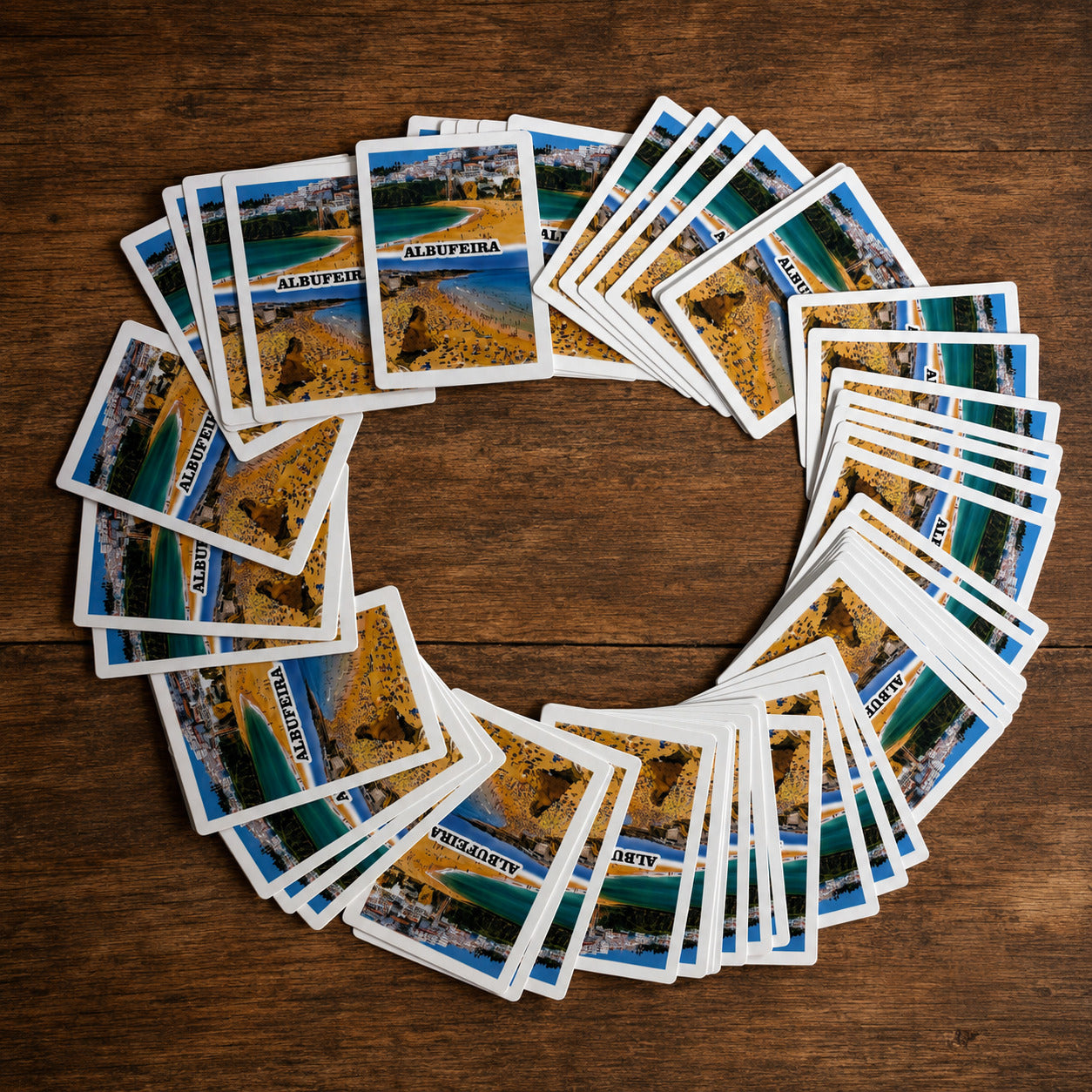 Albufeira souvenir playing cards arranged in a circular display showing Portugal-themed beach illustrations.
