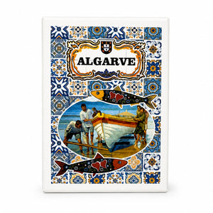 Front view of Algarve souvenir playing card box with Portuguese azulejo tile pattern, sardines, and fishermen launching a traditional boat by the sea.