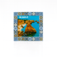 Magnet featuring a scenic coastal photograph of the Algarve, bordered by traditional Portuguese azulejo tile patterns in colorful ceramic-inspired designs