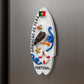 Decorative wall plaque with a bird design and text on a metallic surface