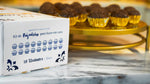 Portugal brigadeiro cooking kit box with finished chocolate brigadeiros in golden paper cups