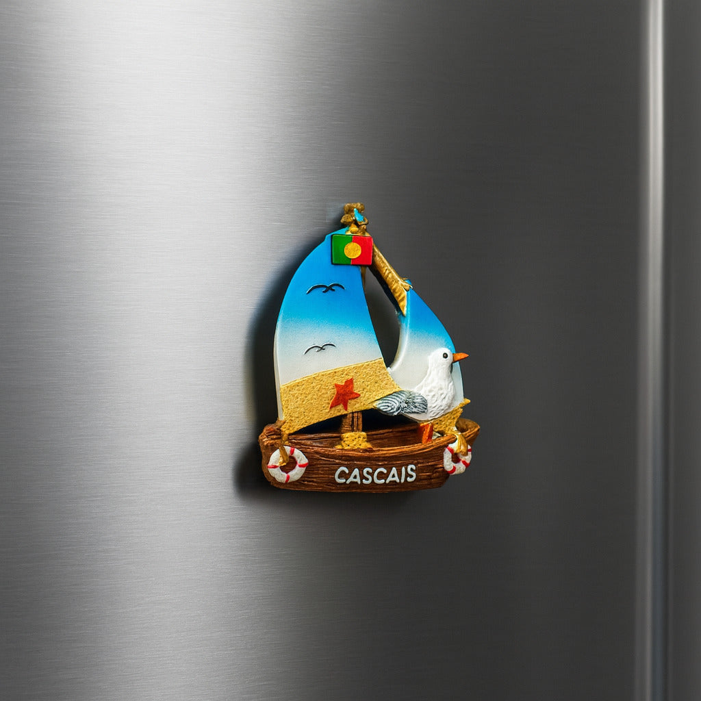 Decorative magnet of a sailboat with a bird on a metallic surface