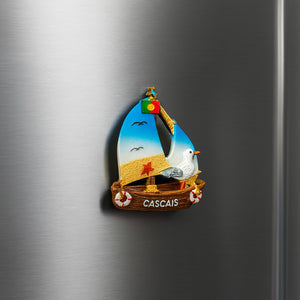 Decorative magnet of a sailboat with a bird on a metallic surface