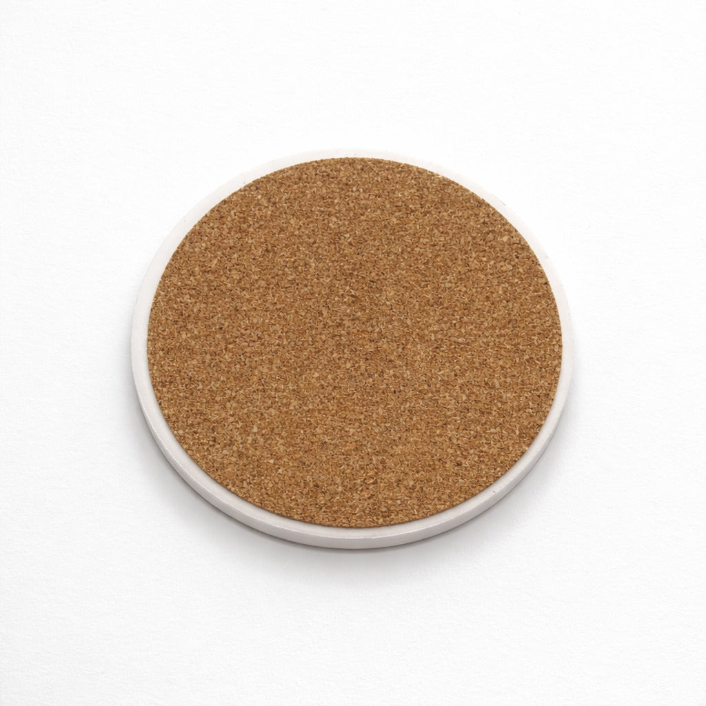 Back of a coaster showing natural cork base on a white background