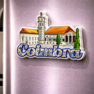 Coimbra souvenir magnet placed on a fridge with illustrated historic building, central tower and tile-inspired lettering