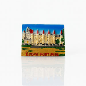 A 3D relief fridge magnet featuring the historic cathedral in Évora, Portugal, with red turrets and a blue sky background, labeled Évora Portugal.