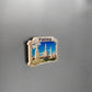 Fridge magnet with a scenic view of Fátima on a metallic surface