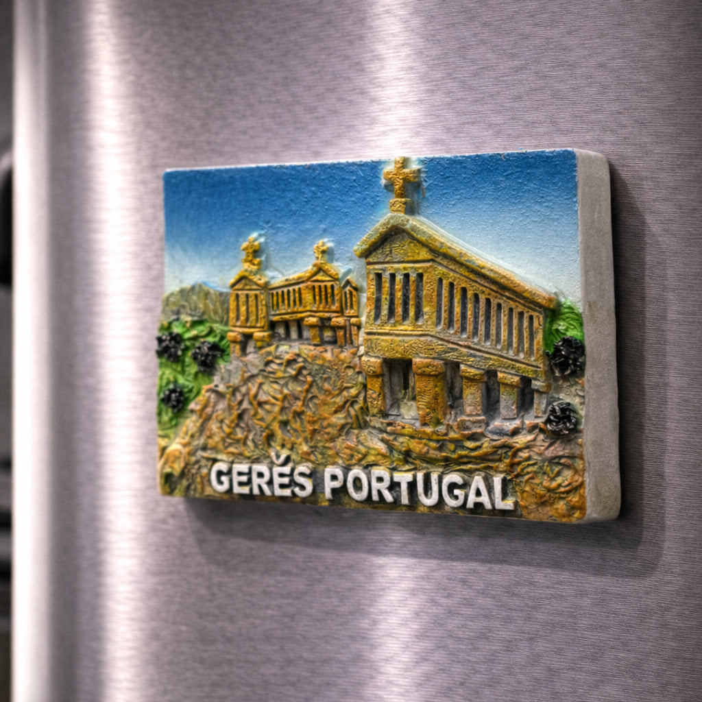 Gerês Portugal souvenir magnet placed on a fridge featuring a raised monument design with crosses, stone textures, and mountain landscape relief