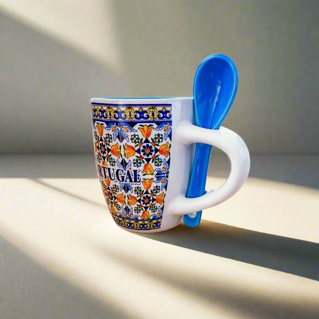 A decorative ceramic coffee cup with a blue and white pattern, representing a charming souvenir from Portugal.