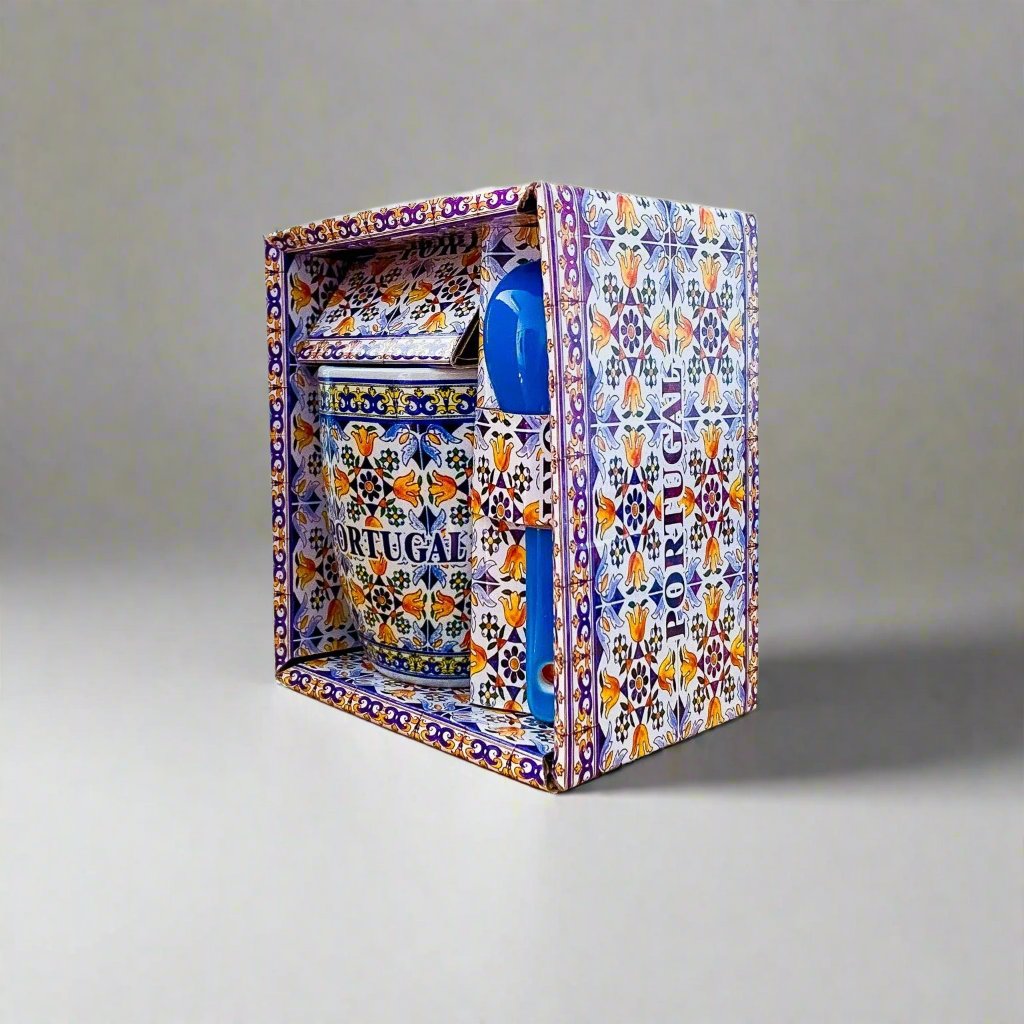 A ceramic coffee cup with an intricate blue and white design, highlighting its origin as a souvenir from Portugal.