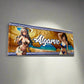 Decorative sign with anime-style characters and 'Algarve' text on a plain wall.