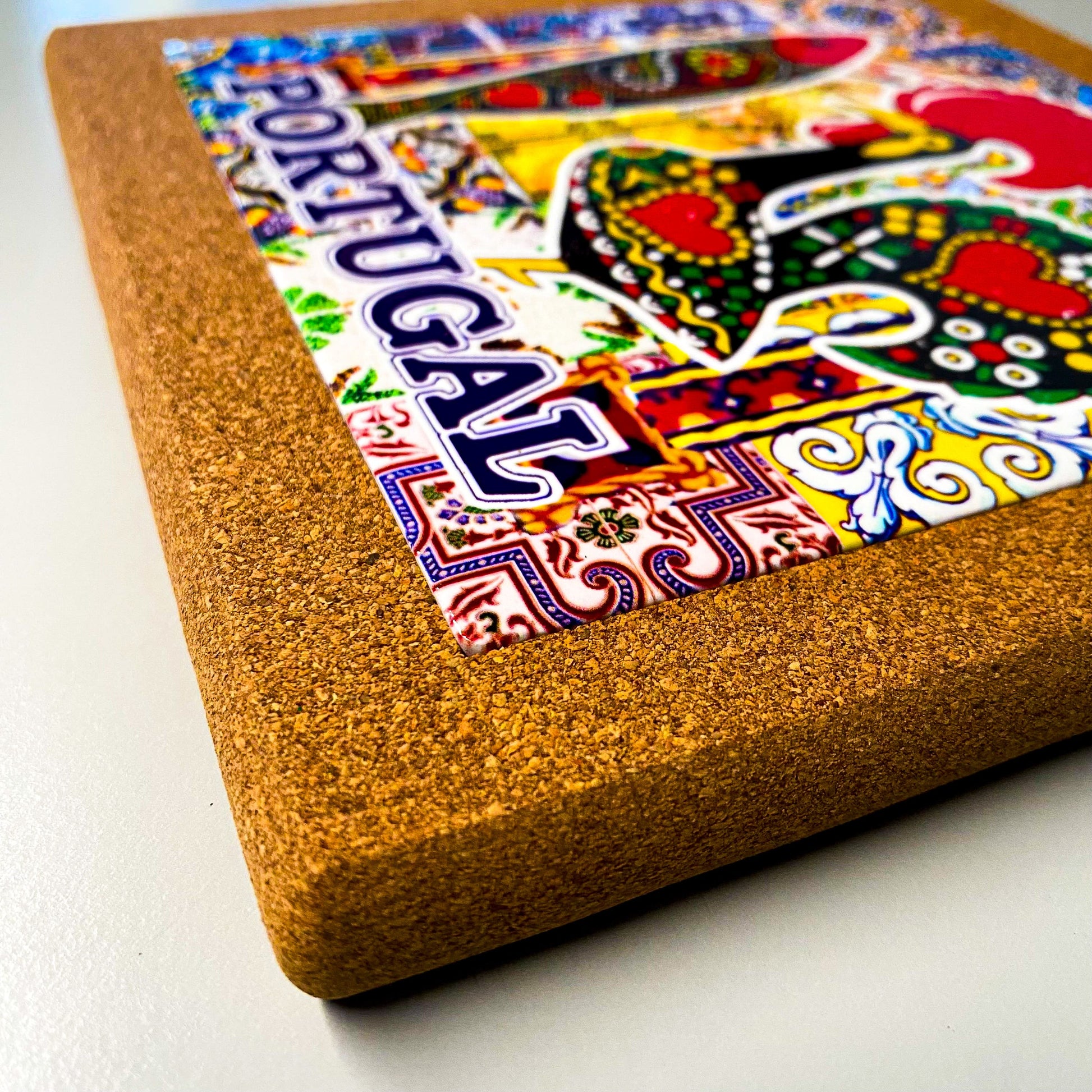 Portugal cork trivet showing colorful rooster, sardine and azulejo motifs