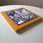 Cork coaster with blue and white pattern on a white surface