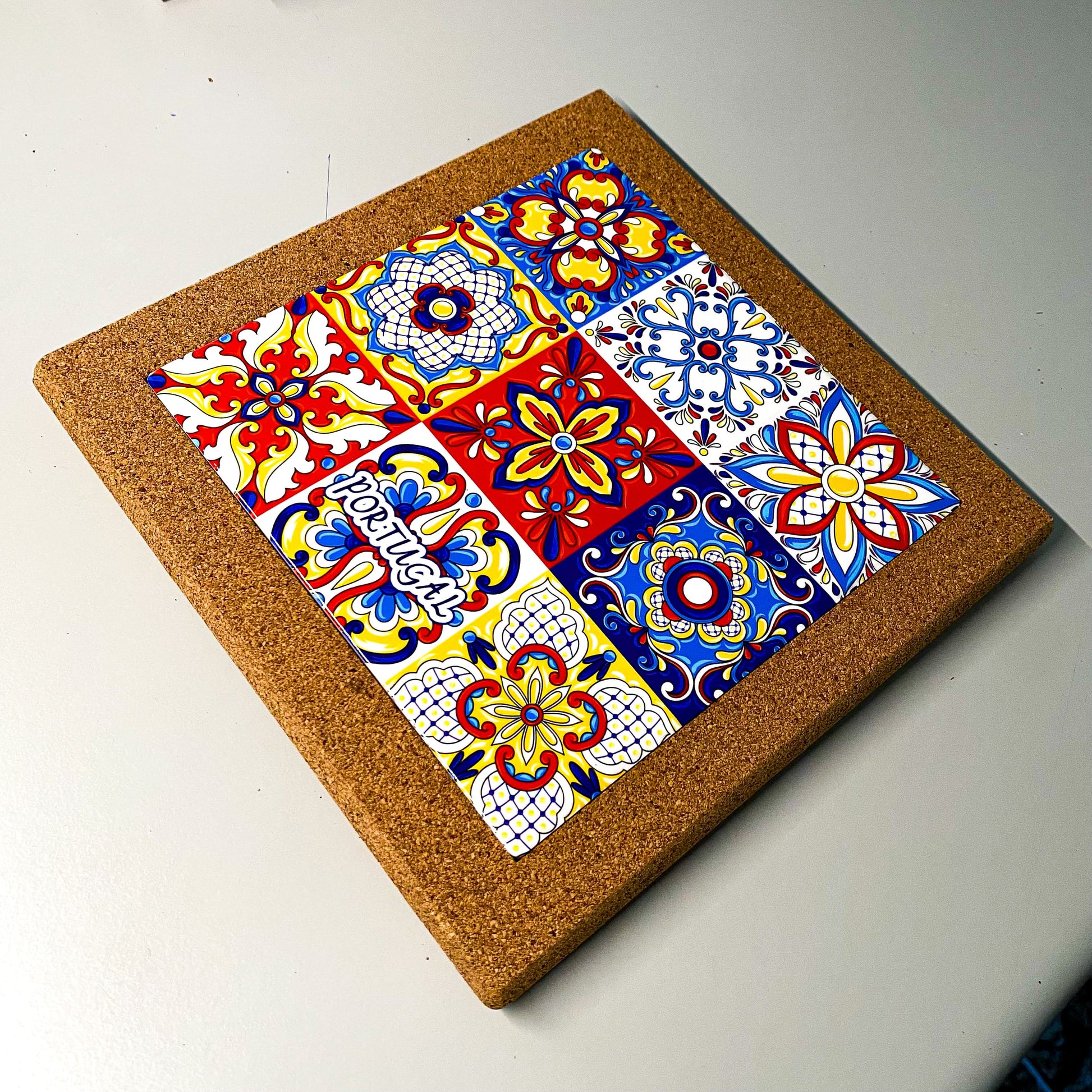 Cork trivet showing nine-tile azulejo mosaic design from Portugal