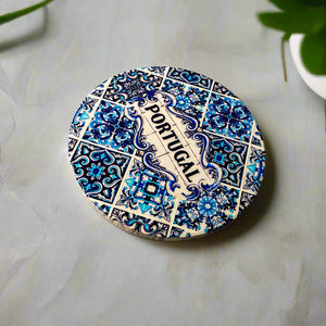 Decorative plate with blue floral patterns and 'Portugal' text on a beige background