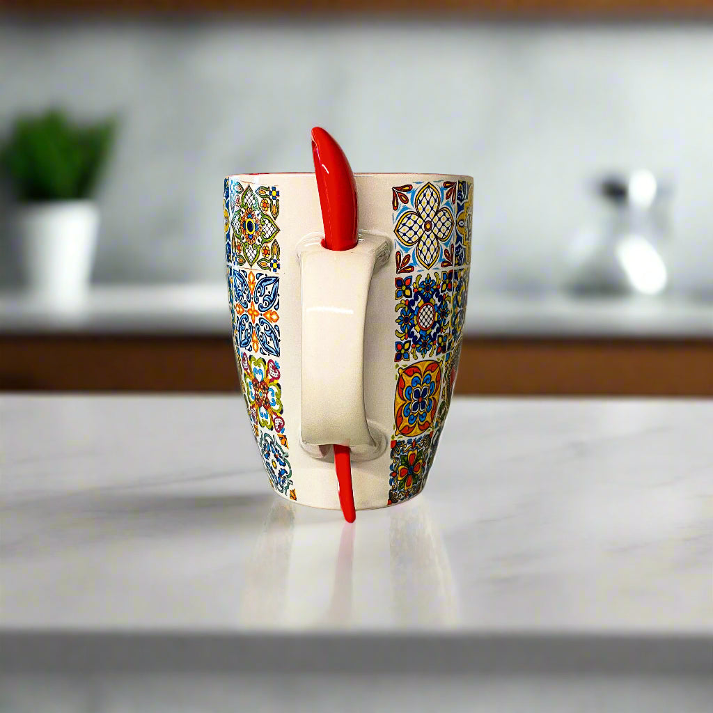 Colorful mug with a red object inside on a white surface