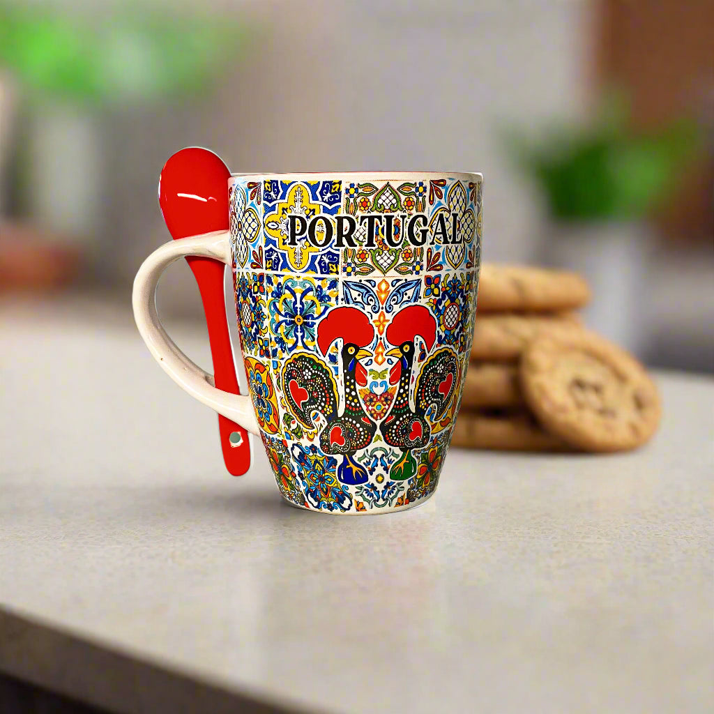 Colorful mug with 'Portugal' design on a kitchen counter with cookies and a spoon.