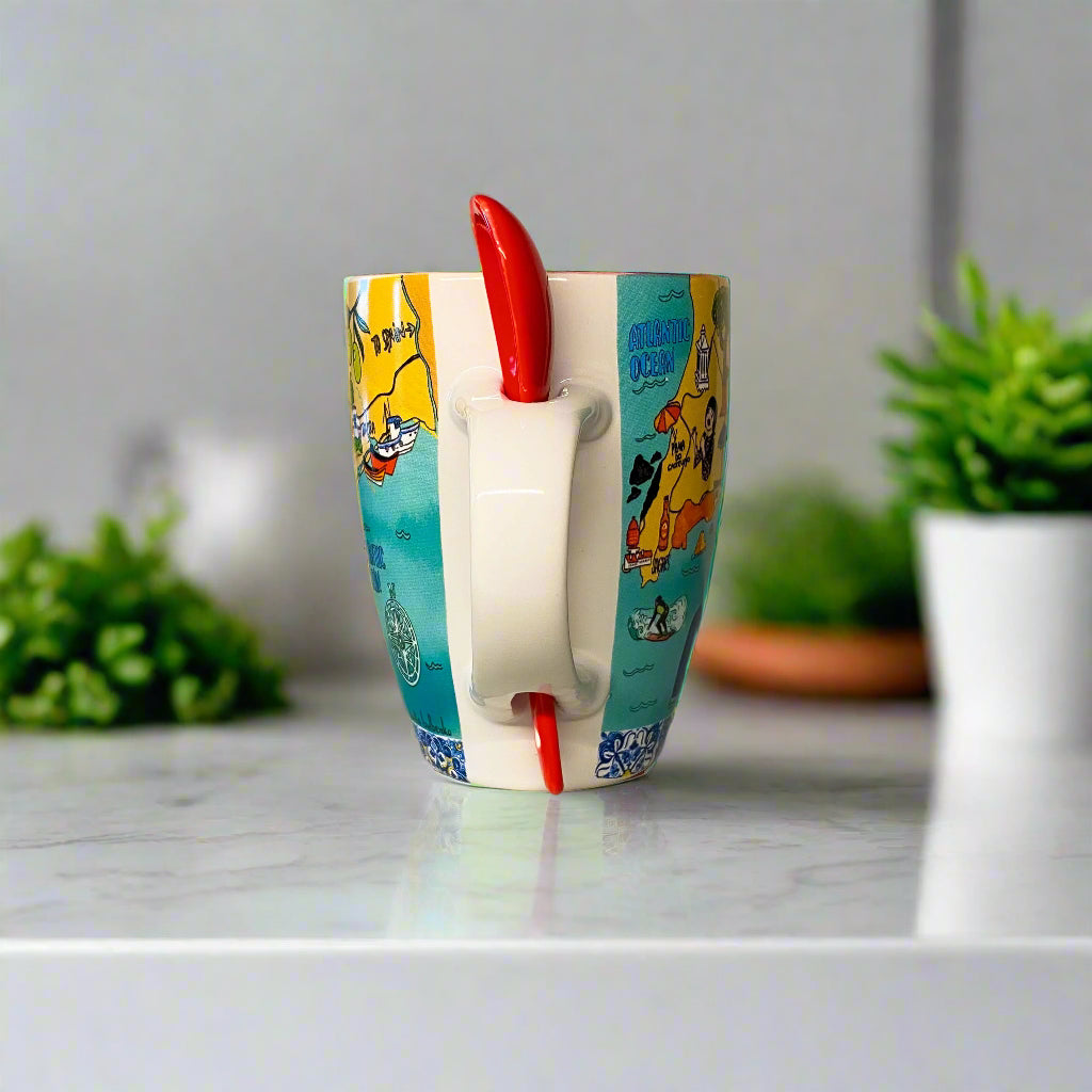 Mug with cartoon design and red handle on a plain background