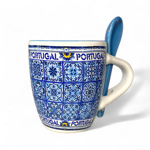 Mug with blue and white pattern and Portugal text, accompanied by a blue spoon on a white background