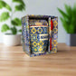 Decorative mug with colorful patterns in a matching box on a neutral background