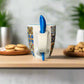 Colorful mug with a blue spoon on a neutral background